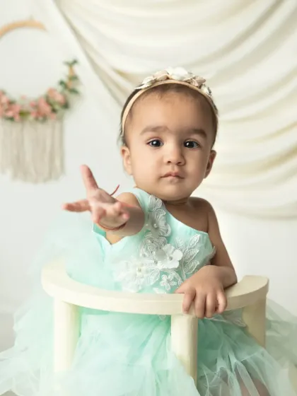 Reaching out to the camera. I love capturing these interactive moments that show your baby's curiosity and engagement with the world.