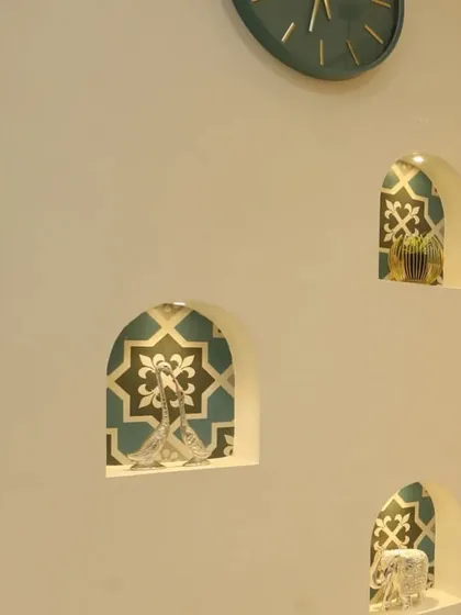 A close-up of the custom-built niches next to the wash basin. Lined with traditional patterned tiles, these small, illuminated arches are perfect for showcasing decorative items and adding character to the wall.