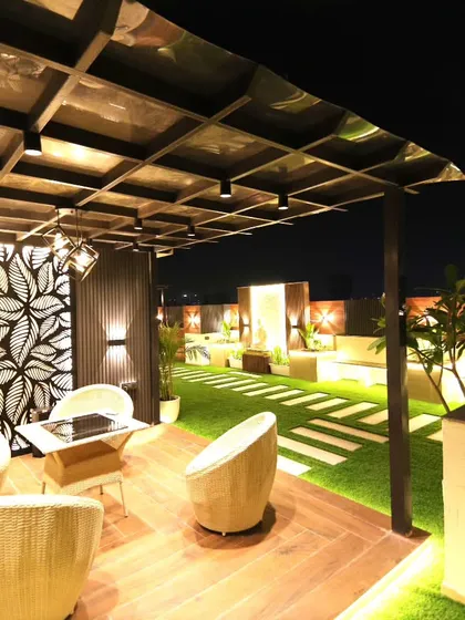 This angle highlights the decorative leaf-patterned jaali panel and the unique gridded ceiling of the pergola.
