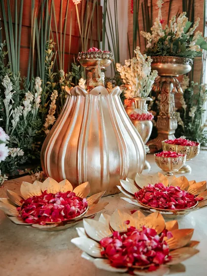 A collection of brass urlis and lotus-shaped bowls, adding a touch of metallic sheen and traditional charm.
