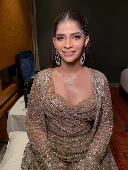 A happy client ready for her Sufi night celebration, with a hairstyle that is both glamorous and unique.