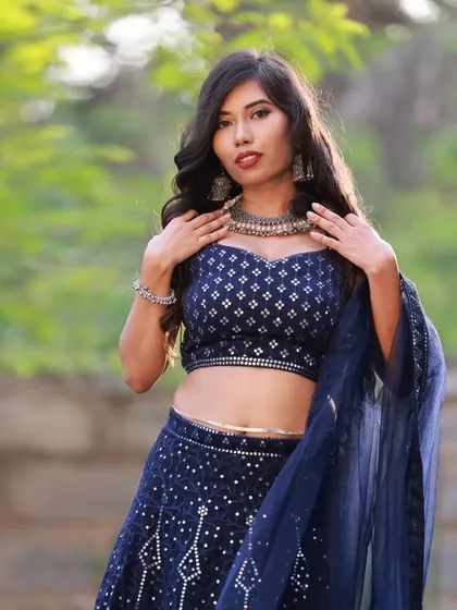 A close-up portrait to highlight the details of the collaboration. The model's expression, the oxidized silver jewellery, and the sequin work on the blouse are all the focus of this outdoor ethnic wear shot.