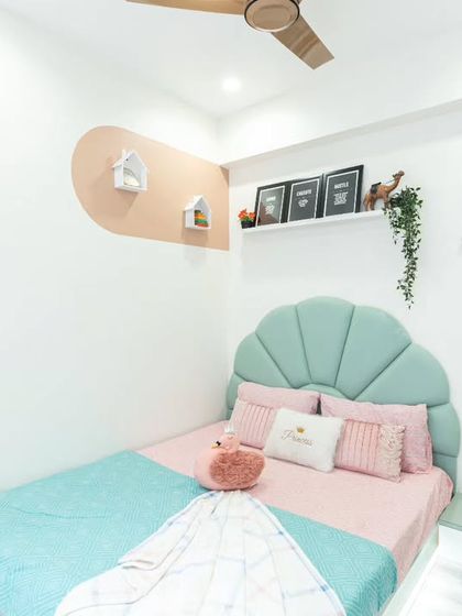 A wider view of the daughter's bedroom, showing how the bed, wardrobe, and study area are all designed to be part of a cohesive and charming theme.
