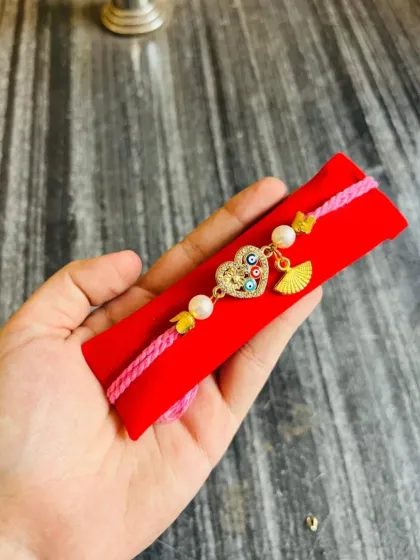 Another variation of our adjustable evil eye heart charm bracelet, this one with a delicate fan charm.