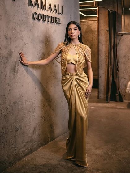 The full look of the mustard draped skirt and cutwork cape set, a look that blends tradition with a contemporary twist.