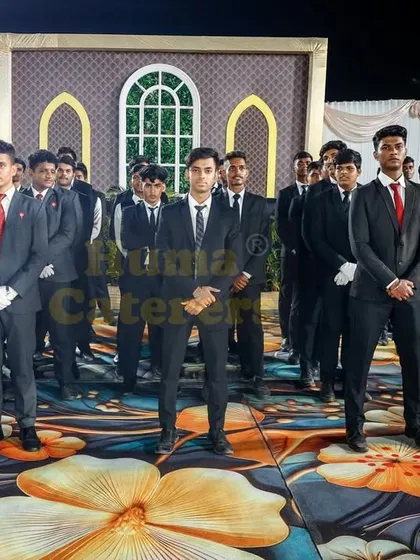 Our team of male servers in sharp black suits with red ties, presenting a modern and professional look for corporate events and formal functions.