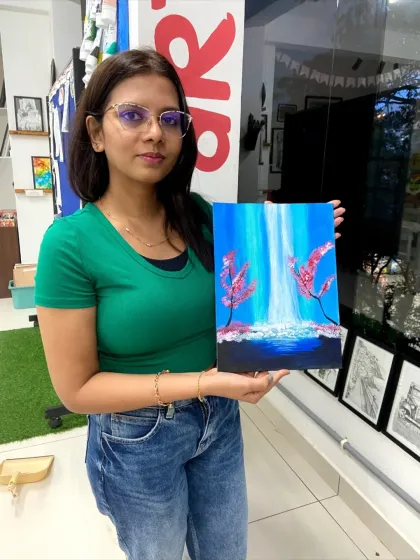 A participant with her finished waterfall painting. The techniques for creating the illusion of flowing water are a key part of this workshop.