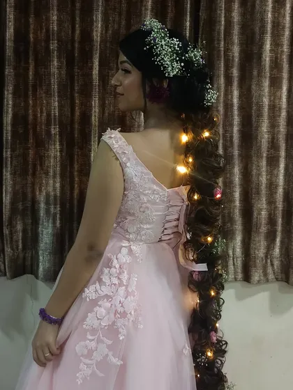 The back of this pink gown features a corset tie-up, adding to the fairytale aesthetic.