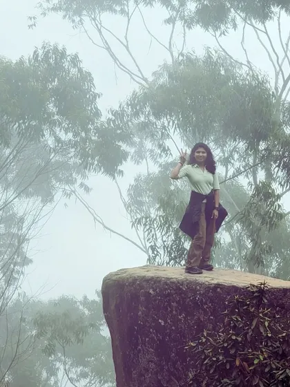 Standing on the edge at Dolphin's Nose in Kodaikanal, with the misty valley below. It's a thrilling viewpoint that offers a spectacular perspective of the surrounding landscape.