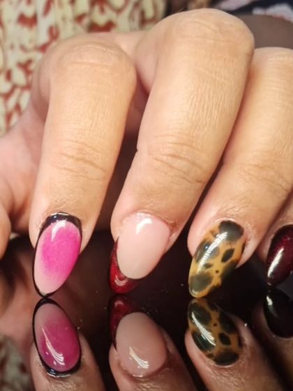 A close-up of the eclectic manicure, showing the detail in the comic-book and leopard print nails.