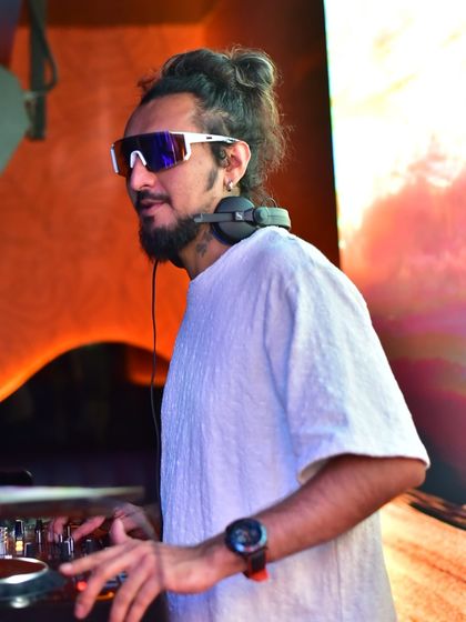 In the zone, mixing tracks while the VJ screen displays a beautiful sunset visual, perfectly matching the mood of the music.