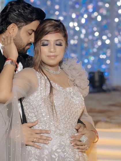 A tender, candid moment on the dance floor. Nikhil's gentle embrace and Srishti's serene expression create a beautiful, emotional image amidst the celebration.