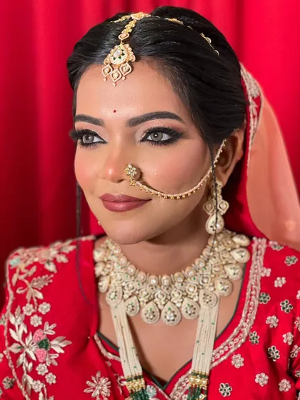 A close-up of the bride's face, highlighting her striking eyes and the beautiful jewellery.