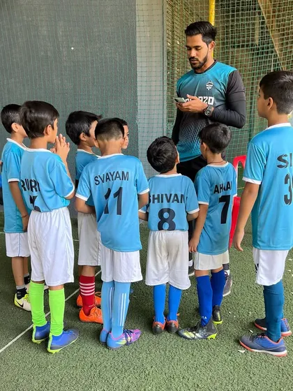 Another angle of a team talk, showing the players' rapt attention as they listen to their coach.