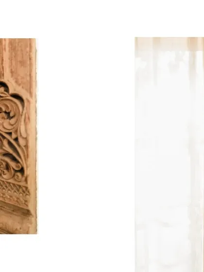 A close-up of a carved wooden element next to an exposed brick wall. The contrast between the refined craftsmanship of the wood and the rustic texture of the brick is something we love to explore.