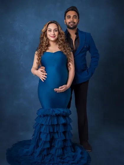 A classic full-length portrait of the couple in their coordinated blue outfits, radiating elegance and joy.