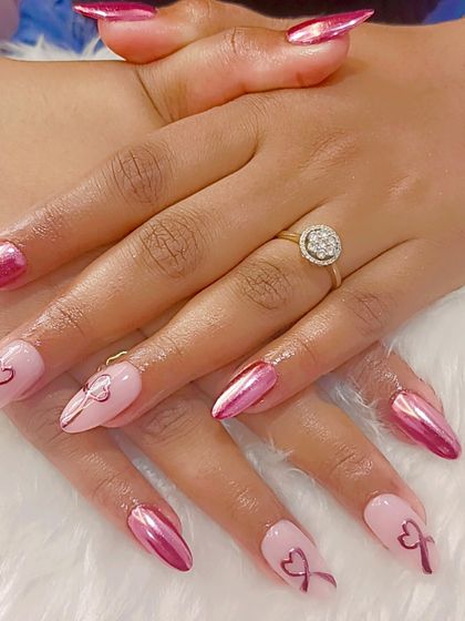 A different angle of the pink chrome and bow art set, highlighting the contrast between the metallic and matte-like finishes.