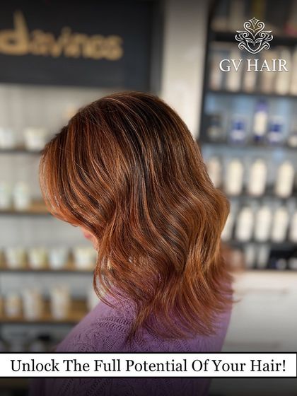 Unlock the full potential of your hair. This reddish-brown color, seen against our Davines product shelf, is vibrant and healthy.