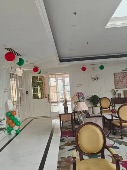 A wide shot of a building lobby decorated for Republic Day, showing how hanging paper lanterns and balloon pillars can work together to create a cohesive and festive look across a large space.