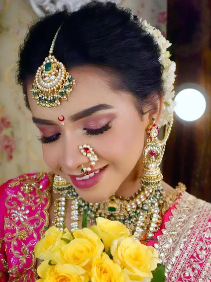 The happy smile of a model showcasing a complete Maharashtrian bridal look. The combination of jewellery, makeup, and flowers creates a stunning result.