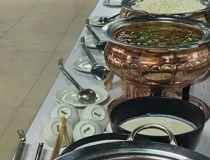 Our standard setup for a corporate buffet, featuring our signature copper serving dishes for main courses like dal makhani, alongside steamed rice and fresh raita. We provide a complete and reliable solution for your office catering needs.