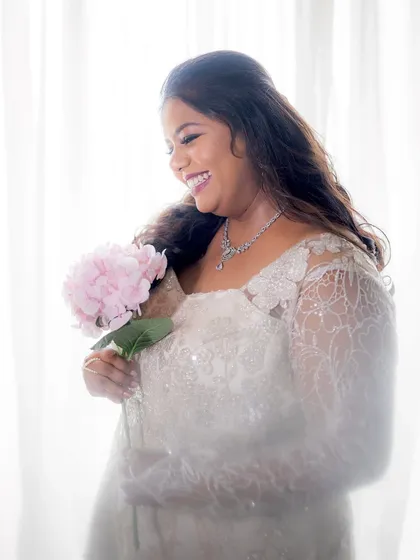 A dreamy, high-key portrait of the bride, looking angelic in her white gown.