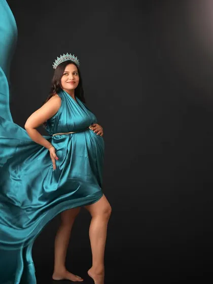 Radiant and ready for the journey ahead. This portrait captures the mom-to-be in a flowing teal gown, looking like a queen under the light of the moon.