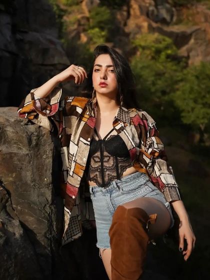 Adding knee-high boots to the shorts and shirt combo for a more edgy, fashion-forward vibe.