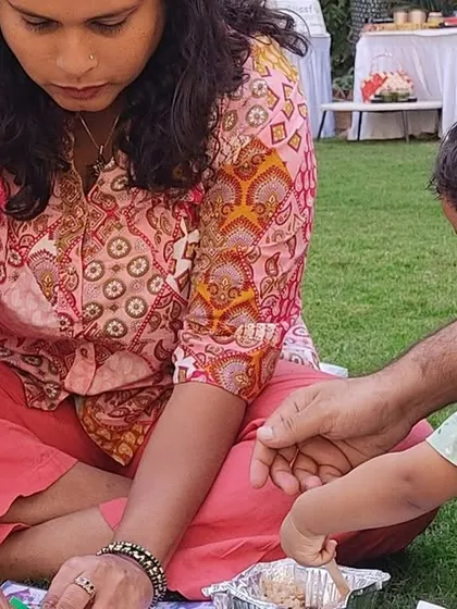 A family enjoying the Kids Kona, with a child engaged in a craft activity.
