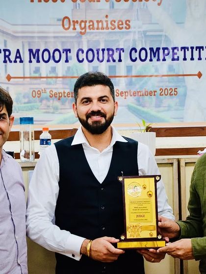 Posing with a plaque alongside other dignitaries at the Intra Moot Court Competition. Events like these are vital for fostering a culture of excellence in legal advocacy.