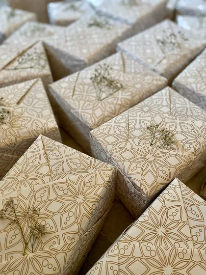 We believe presentation is part of the gift. Here’s a look at a bulk order of wedding favours, each one wrapped in elegant, recycled paper and finished with a sprig of dried baby's breath. It’s our way of ensuring your gifts are as beautiful on the outside as they are on the inside.