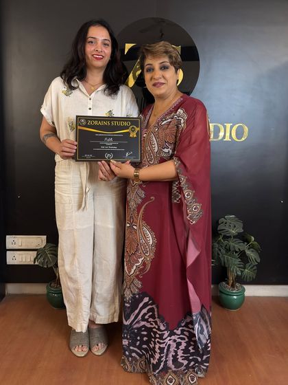 A happy graduate receives her certificate. Congratulations.