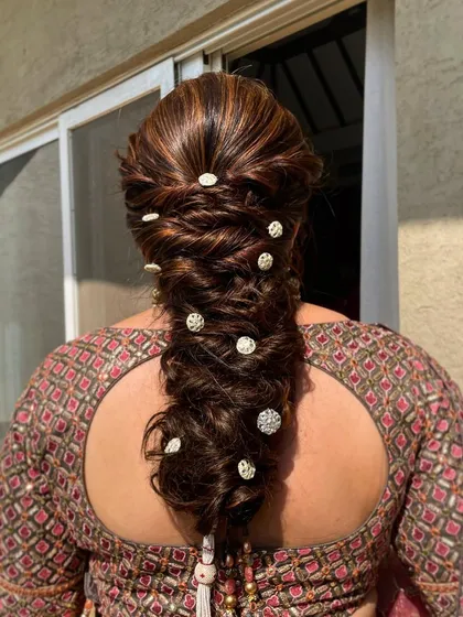 A close-up of the intricate bejeweled braid. The mix of textures and sparkling elements makes this a truly special occasion hairstyle.