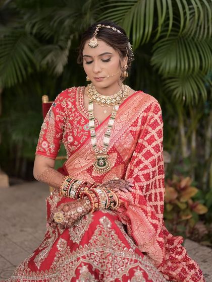 A serene portrait of the Gujarati bride, her hair neatly styled to showcase her beautiful features and traditional jewelry.