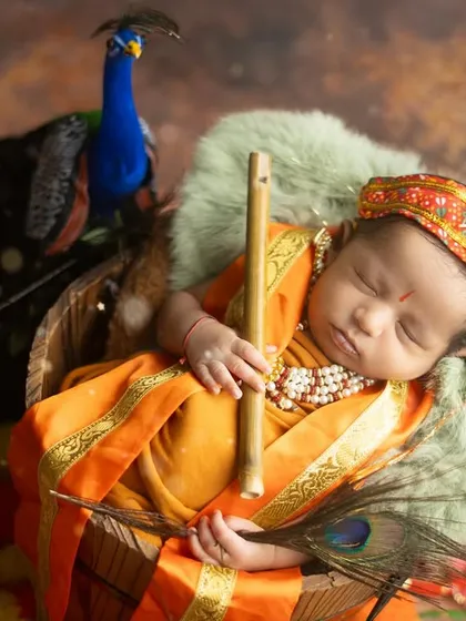 This is my Little Kanha, peacefully dreaming. I specialize in creating these divine, themed newborn shoots for Janmashtami, complete with props like peacock feathers and a flute.