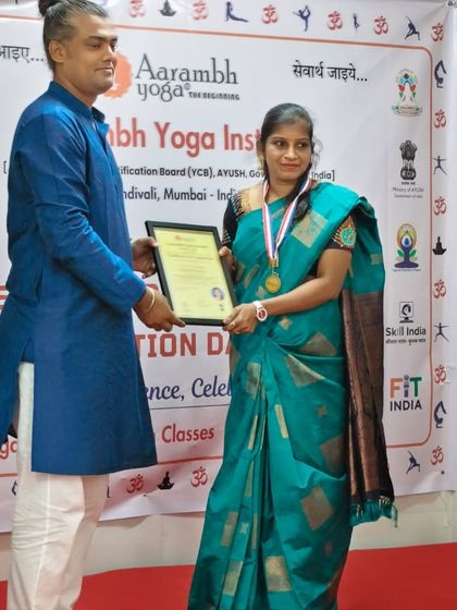 An instructor presents a certificate to a student, acknowledging her hard work and welcoming her into our community of certified teachers.