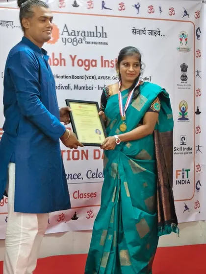 An instructor presents a certificate to a student, acknowledging her hard work and welcoming her into our community of certified teachers.