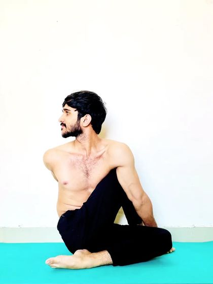 A seated spinal twist, showing the importance of rotating from the core to get the full benefit of the pose.