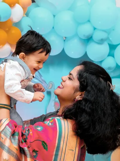 A heartwarming moment between mother and child, full of smiles and joy. These are the candid shots that truly tell the story of the day.