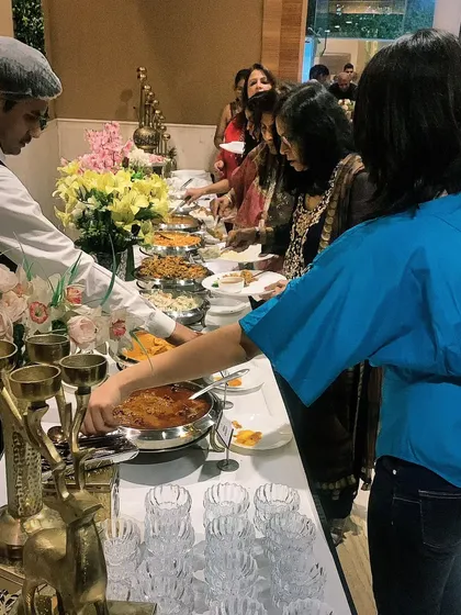Here, guests are enjoying a delicious buffet spread I crafted for a party of 50. I love seeing people connect over good food, and my setups are designed to encourage a warm, communal dining experience.