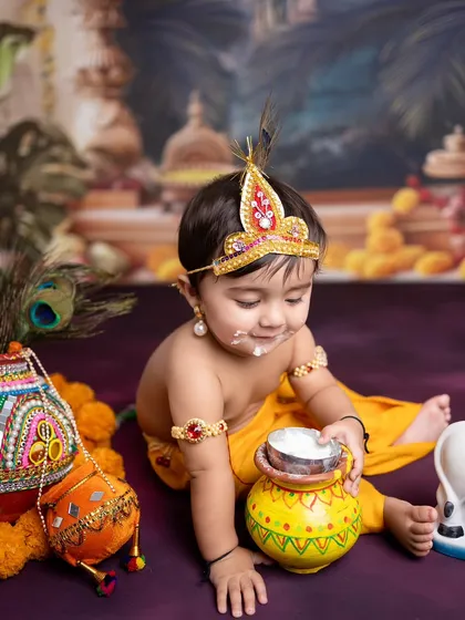 A playful moment as our little Krishna gets a bit of 'maakhan' on his face. These unscripted moments often make the best photos.