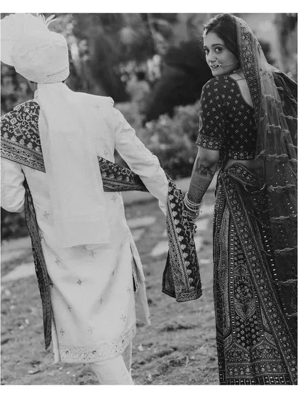 Leading the way to their future. This black and white shot of Saniya leading Aman by the hand, with a glance back at the camera, is a beautiful, narrative-driven portrait.