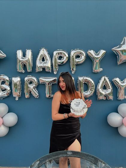 A fun birthday shot with a cake and "Happy Birthday" balloons. This is a more casual but equally joyful celebration.