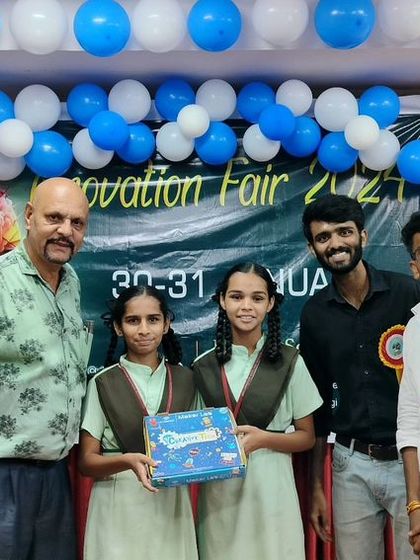 Our team proudly accepts an award on behalf of our students at a science fair. We support our students not just in the lab, but also in showcasing their work to the wider community.