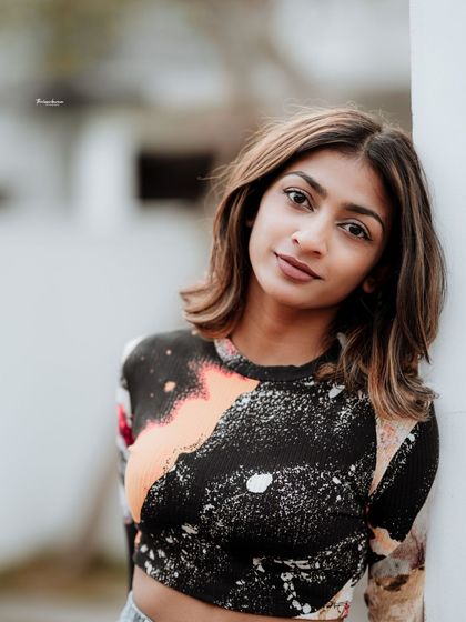 A classic portrait pose with a gentle smile. The soft lighting and direct eye contact create a beautiful and engaging image.