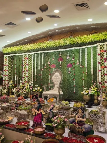 An angled view of the banana leaf stage, showing the extensive offering table.