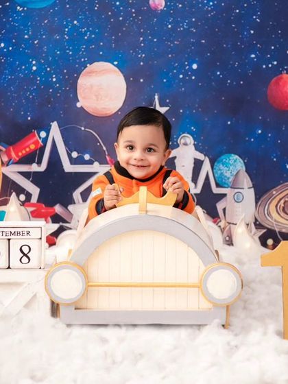 An astronaut exploring the cosmos. This wide shot shows the full, detailed space theme, complete with planets and stars.