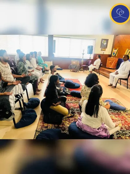 Devotees listening intently during a spiritual discourse. Our satsangs are interactive, with time for questions and sharing to help apply the teachings to daily life.