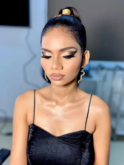 A close up of a fierce and fashionable makeup look. This features a dramatic graphic winged liner, contoured cheeks, and a matte nude lip, demonstrating the precision and artistry taught in my advanced classes.