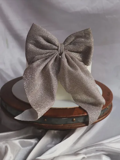 The bow cake is also available with a glittering silver bow for a chic and sophisticated look.